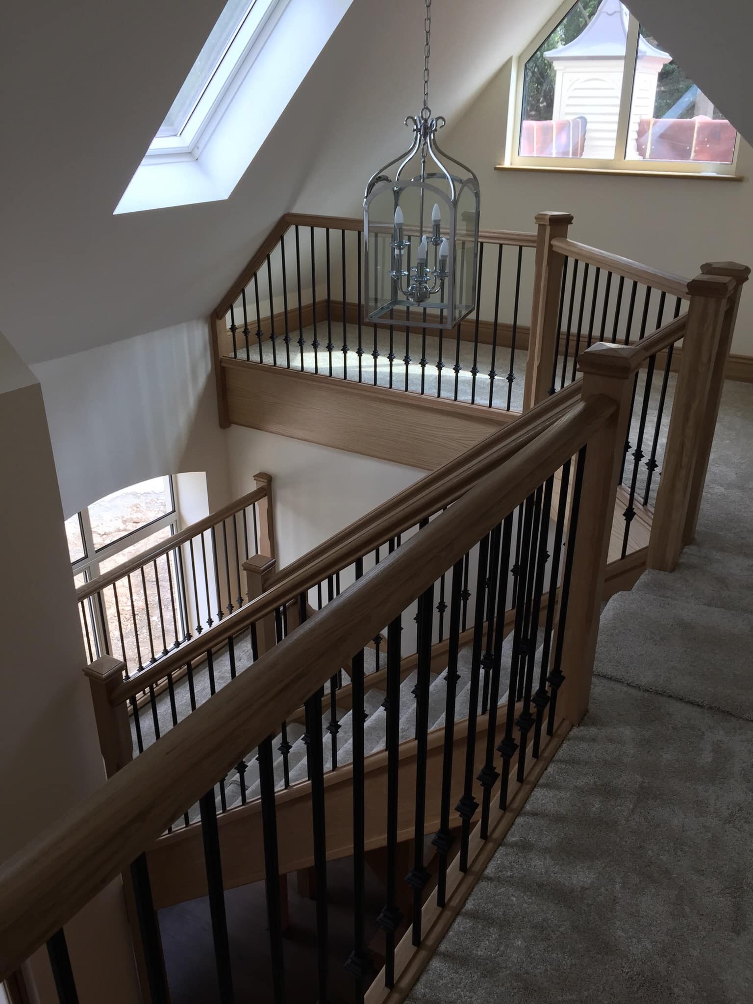 Oak staircase with balustrade leading up to a converted loft